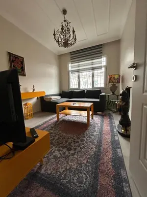 a living room with a couch and a coffee table at Bohemian Antique House in Colorful Balat in Istanbul