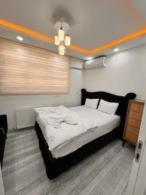 a bedroom with a large bed with white sheets at WhiteBird Apartments in Istanbul