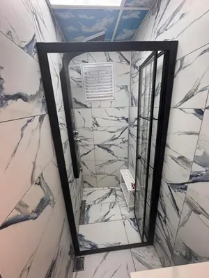 a mirror in a room with marble walls at WhiteBird Apartments in Istanbul