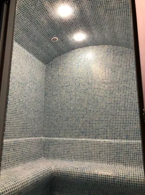 a bathroom with a shower with blue tiles at Imperium Living in Istanbul
