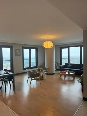 a living room with a couch and tables and windows at Imperium Living in Istanbul