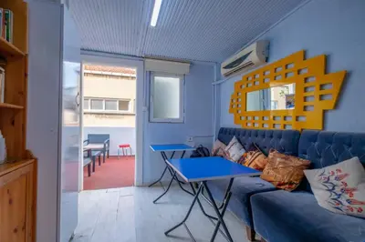 a living room with a blue couch and a table at Çatal hostel in Istanbul