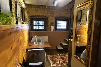 a room with a table and chairs and a mirror at Stories Of Galata in Istanbul