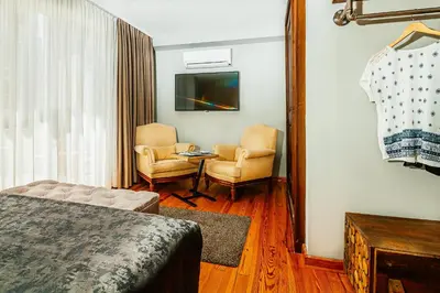 a room with a bed and two chairs and a tv at Stories Of Galata in Istanbul