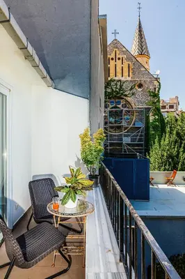 a balcony with two chairs and a table and a building at Stories Of Galata in Istanbul