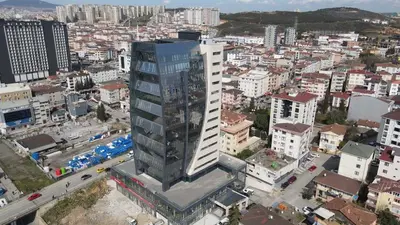an overhead view of a city with a tall building at Plaza Residence in Tuzla