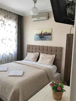 a bedroom with a large bed and a window at Theodora Hostel in Istanbul
