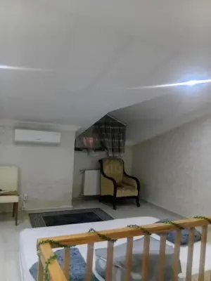 a living room with a couch and a chair at Sağlam Apartments in Istanbul