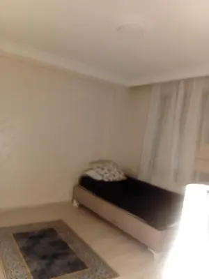 a small bedroom with a bed and a window at Sağlam Apartments in Istanbul
