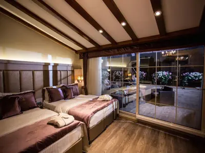 a bedroom with two beds and a large window at Bonne Sante Hotel in Istanbul