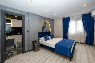 a bedroom with a king sized bed and a bathroom at İstanbul Paradise Hotel in Istanbul