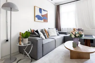 a living room with a gray couch and a table at Stylish Modern Flat Steps from Istiklal in Istanbul