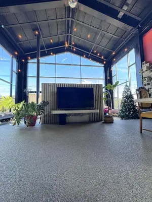 a living room with a large screen tv in a room with plants at Baraka 1 in İznik