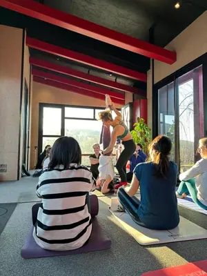 a group of people sitting on the floor watching a woman doing yoga at Baraka 1 in İznik