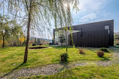 a black building with a tree in front of it at Baraka 1 in İznik