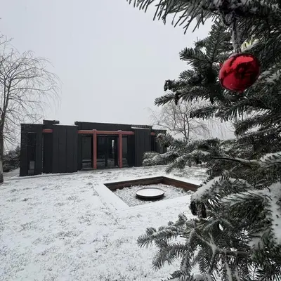 a snowy yard with a christmas tree and a building at Baraka 2 in İznik