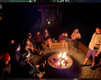 a group of people sitting around a fire pit at Baraka 2 in İznik
