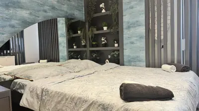 a bedroom with a large bed and a wall with plants at Marine Suite in Istanbul