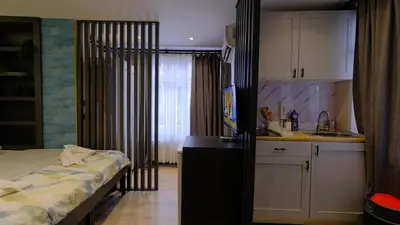 a kitchen with a bed and a sink in a room at Marine Suite in Istanbul