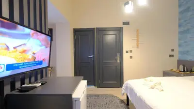 a room with a bed and a flat screen tv at Marine Suite in Istanbul