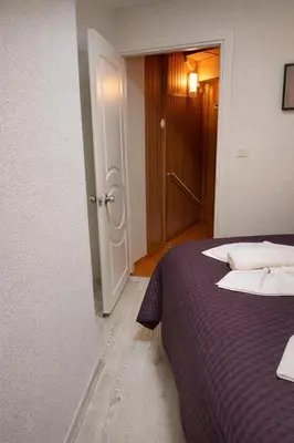 a bedroom with a purple bed and a door at Hes Sultanahmet Tenedos in Istanbul