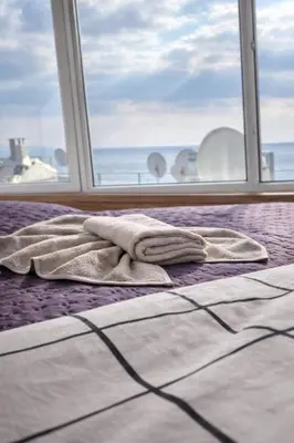 a bed with towels on it in front of a window at Hes Sultanahmet Tenedos in Istanbul