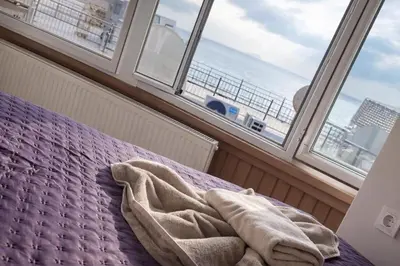 a bed in a room with a large window at Hes Sultanahmet Tenedos in Istanbul