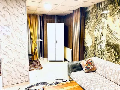 a living room with a couch in front of a door at Nera Otel in Istanbul