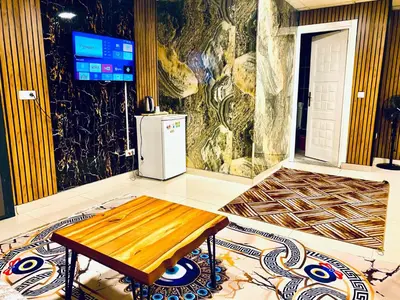 a room with a refrigerator and a table on the floor at Nera Otel in Istanbul