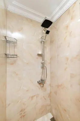 a shower in a bathroom with a tiled wall at Amoria House Sultanahmet in Istanbul
