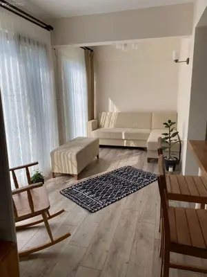 a living room with a couch and a table at sakarya erenlerde köy konsepti doğal yaşam evi in Erenler