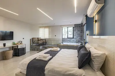 a bedroom with a large bed with two towels on it at Safir Termal & Spa Otel in Çekirge İstasyonu