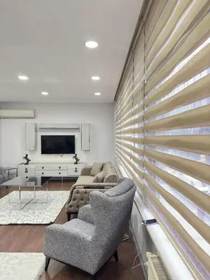 a living room with two chairs and a couch and a television at Ekinci Plaza in Istanbul