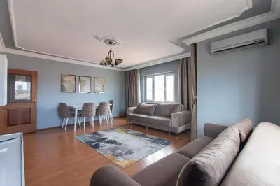a living room with a couch and a table at Spacious & Modern 3BR Apartment Central Şişli in Istanbul