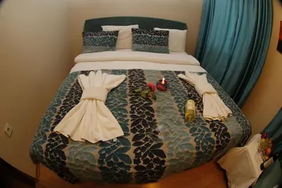 a bedroom with a bed with two dresses on it at BACHOS HOTEL SULTANAHMET sea view terrace in Istanbul