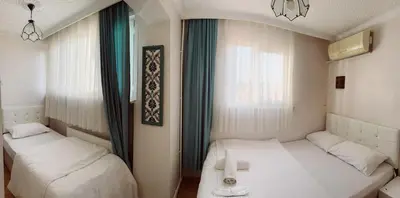 a room with two beds and a window at BACHOS HOTEL SULTANAHMET sea view terrace in Istanbul