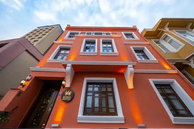 a orange building with many windows on it at King Suite Hotel Beşiktaş in Istanbul