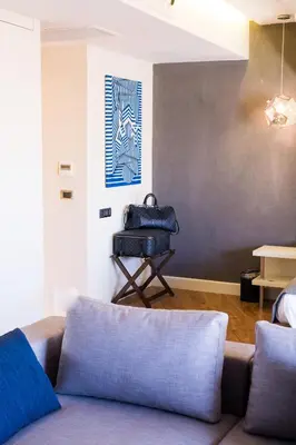 a living room with a couch and a painting on the wall at Maroon Hotel Pera in Istanbul