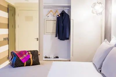 a bedroom with a white bed and a closet at Maroon Hotel Pera in Istanbul