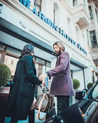 a man and a woman shaking hands on a street at Maroon Hotel Pera in Istanbul