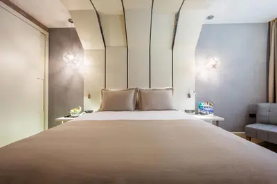 a bedroom with a large bed and a chair at Maroon Hotel Pera in Istanbul
