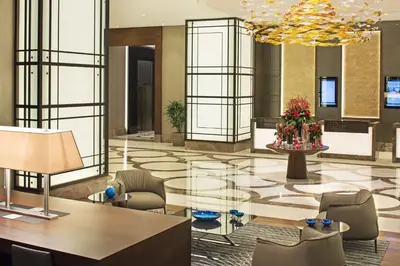a lobby with a table and chairs in a building at Sheraton Grand Istanbul Atasehir in Istanbul