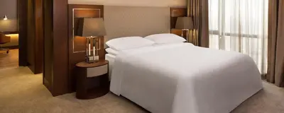 a large white bed in a hotel room at Sheraton Grand Istanbul Atasehir in Istanbul