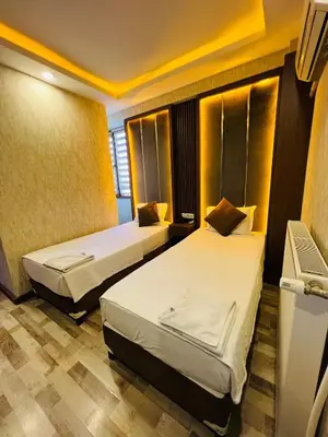 a hotel room with two beds in it at Liman Hotel in Istanbul