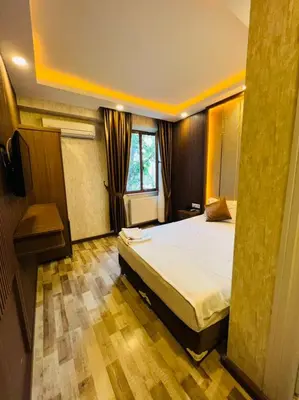 a bedroom with a large bed in a room at Liman Hotel in Istanbul
