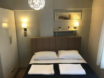 a small bedroom with a bed with two white pillows at Goji's Apartments in Istanbul