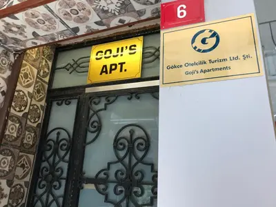 a sign in front of a building with a gate at Goji's Apartments in Istanbul
