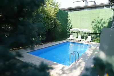 a swimming pool with two lawn chairs at Sapanca Vi̇lla Bahce Şükriye Küçükal in Sapanca