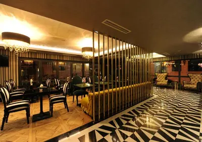 a restaurant with a yellow couch and chairs and tables at Le Petit Palace Hotel - Special Category in Istanbul