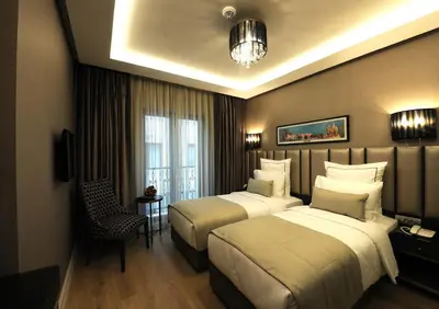 a hotel room with two beds and a window at Le Petit Palace Hotel - Special Category in Istanbul